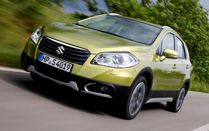 Lime green Suzuki S-Cross driving fast on a blurred road with trees in the background under bright daylight.