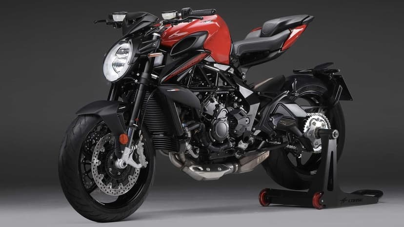 Red and black MV Agusta Brutale sportbike on a rear stand in a dark studio with professional lighting.