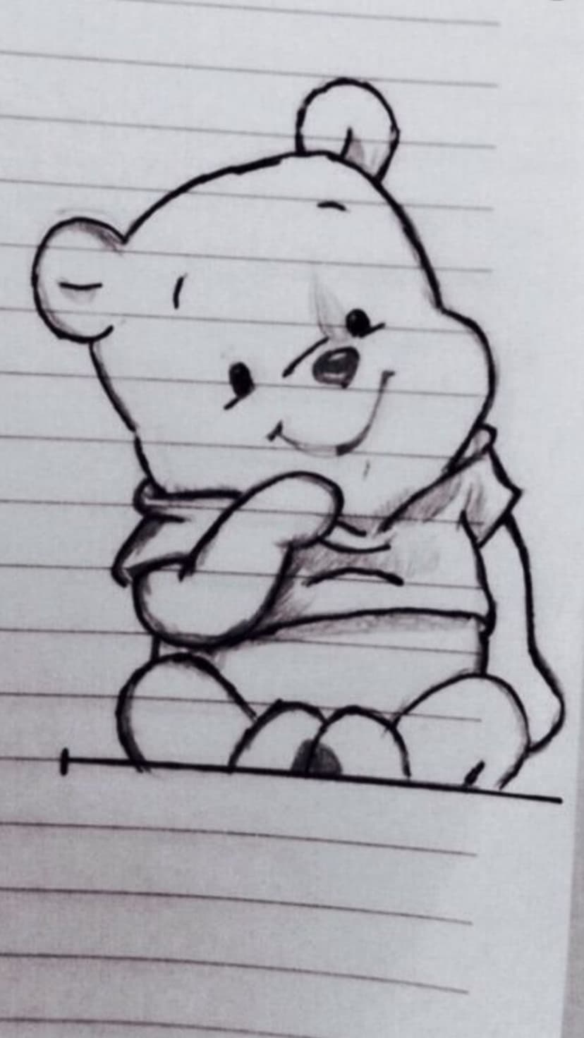 Winnie the Pooh sits smiling while wearing a scarf in a pencil drawing on a page of lined notebook paper.