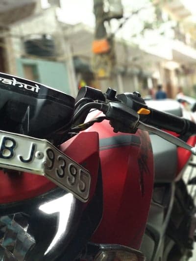 Red motorcycle detail with license plate BJ 9395