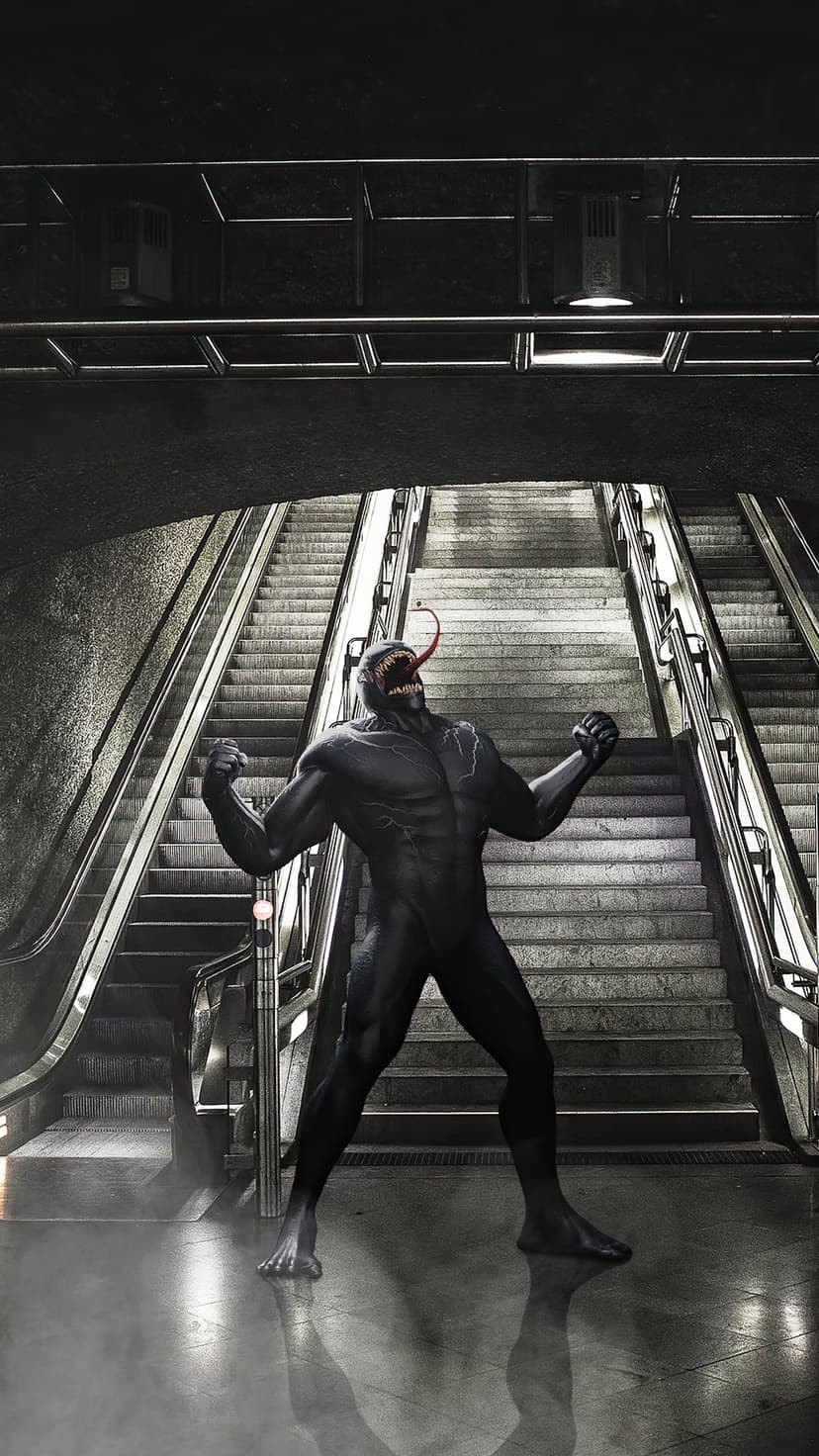 Venom snarls at the base of subway stairs with a long red tongue extended in a dark underground station.