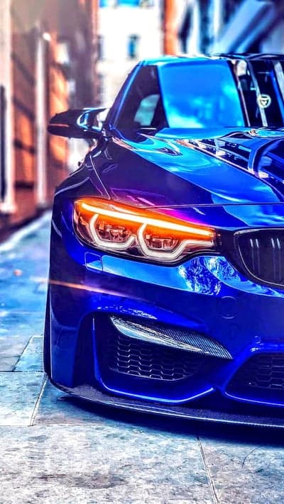 Blue BMW M4 Coupe Illuminated Headlights Phone Wallpaper