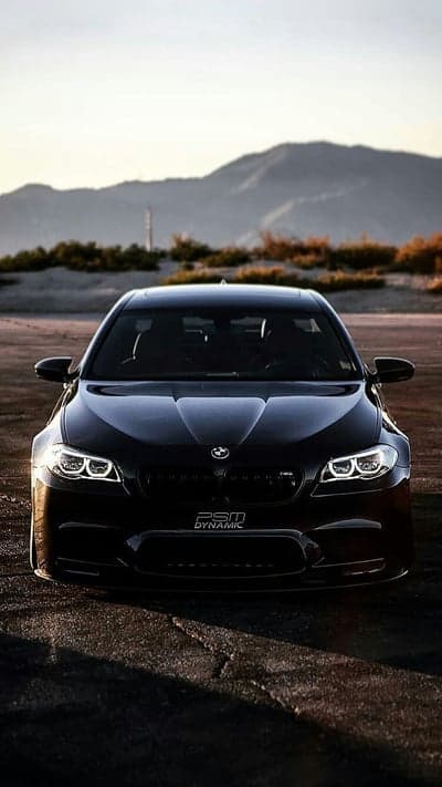 Black BMW M5 parked in a desert landscape