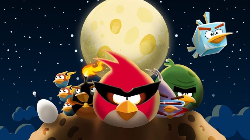 Angry Birds characters in space gear stand on a cratered asteroid with a large cheese moon and stars behind.