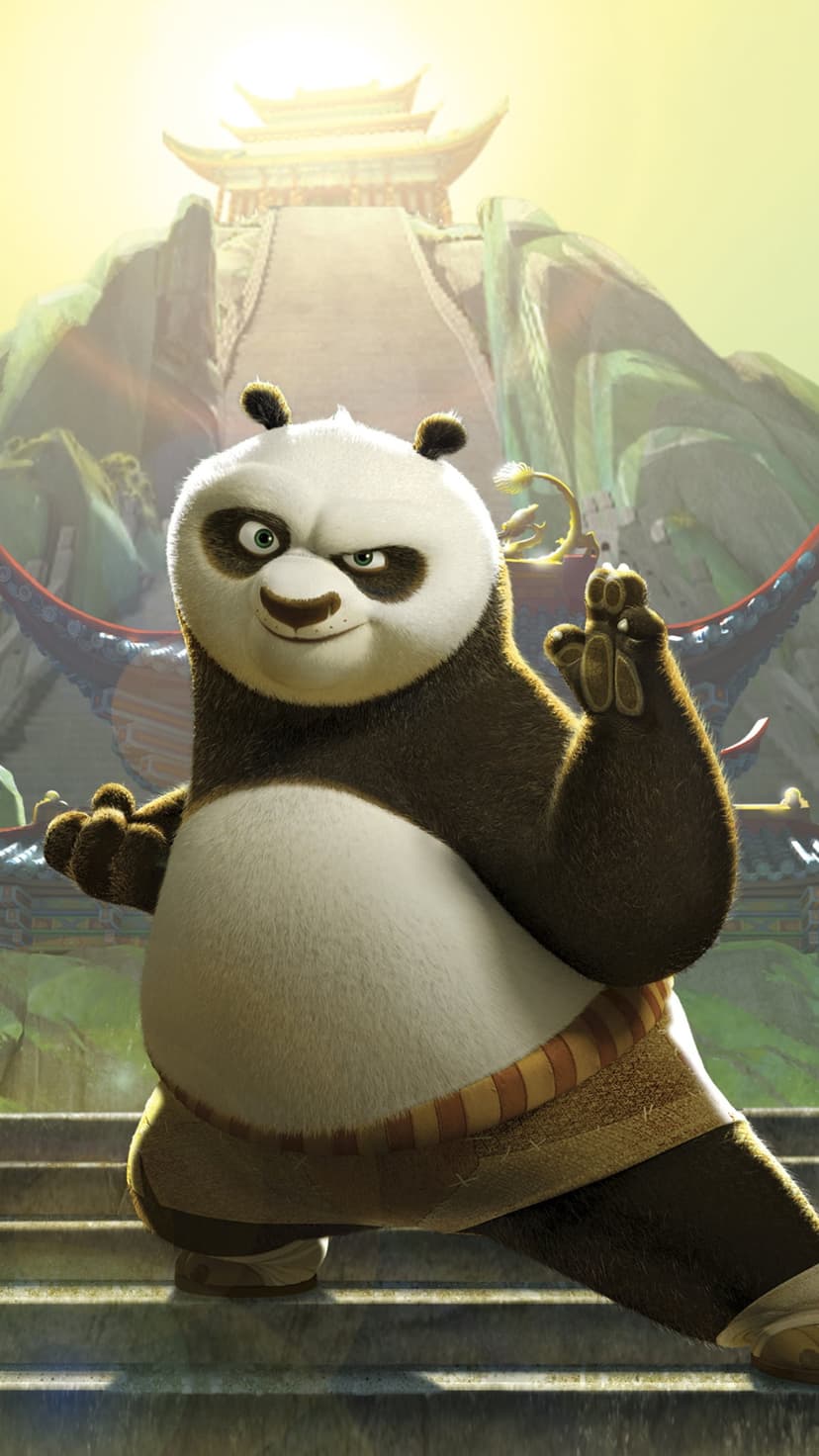 Po the panda strikes a martial arts pose on stone stairs with a misty mountain temple background at sunrise.