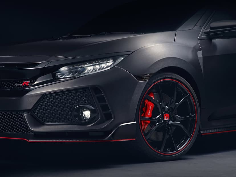 Dark grey Honda Civic Type R front view with LED headlights, red brake calipers, and matte body texture.