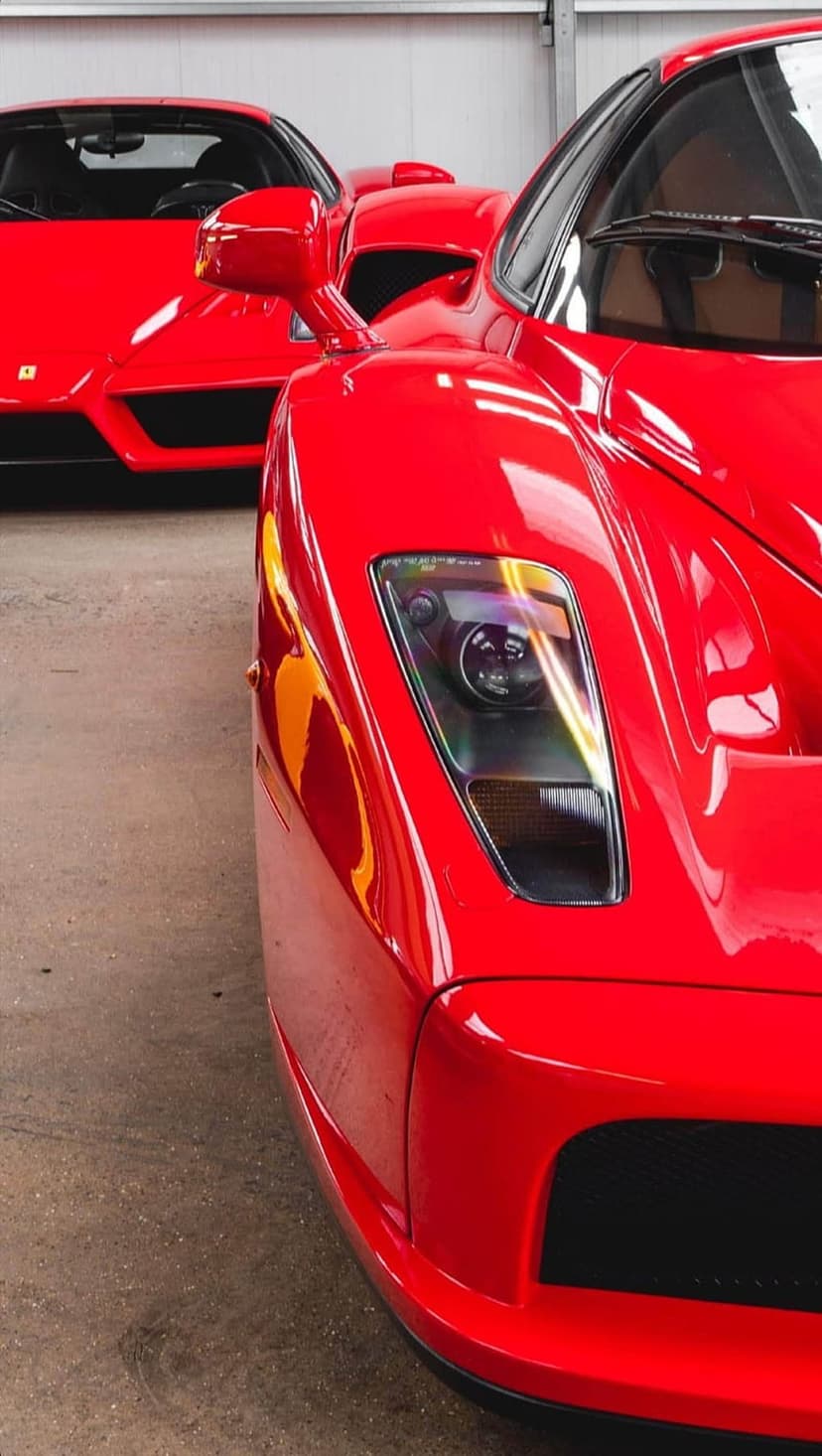 Ferrari headlight and red glossy bodywork show intricate lens details and reflections on a mobile screen.
