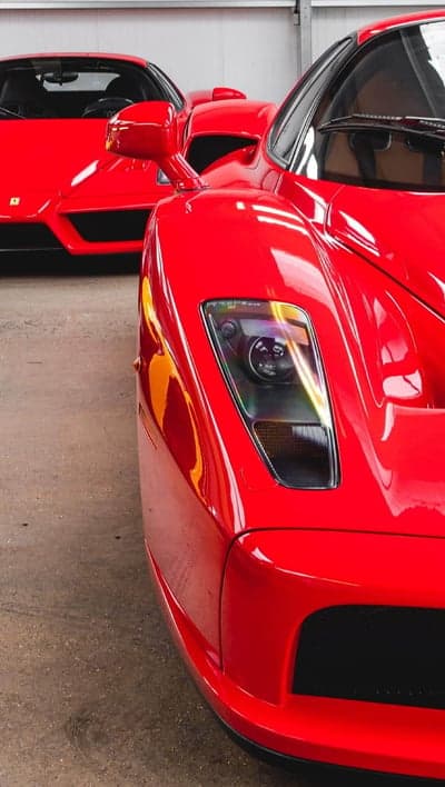 Sleek Red Ferrari Sportscar Headlight Phone Background