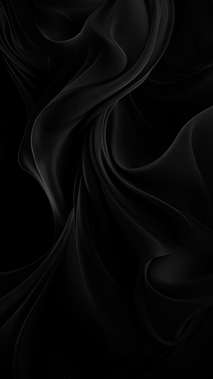 Black fabric swirls with deep shadows and soft highlights forming elegant monochrome waves and folds.