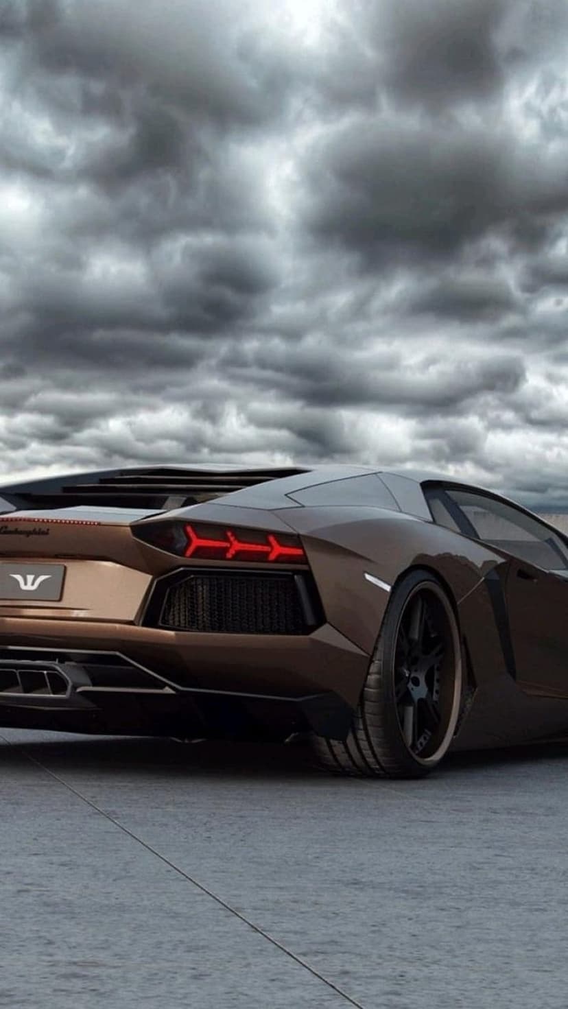 Lamborghini Aventador rear view featuring red LED tail lights under a turbulent dark sky with brown bodywork.