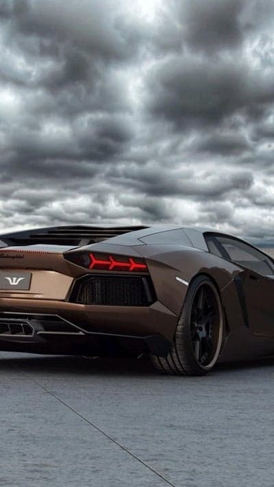 Brown Lamborghini Aventador Tail Lights Under Stormy Skies