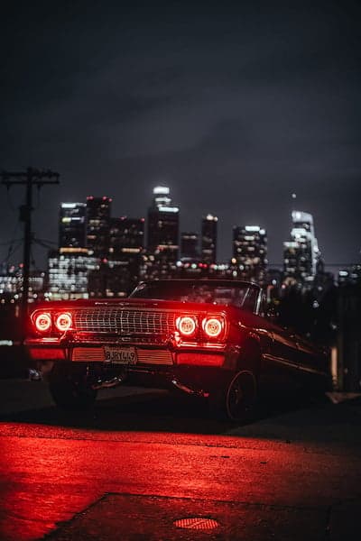 Lowrider Car with City Lights at Night