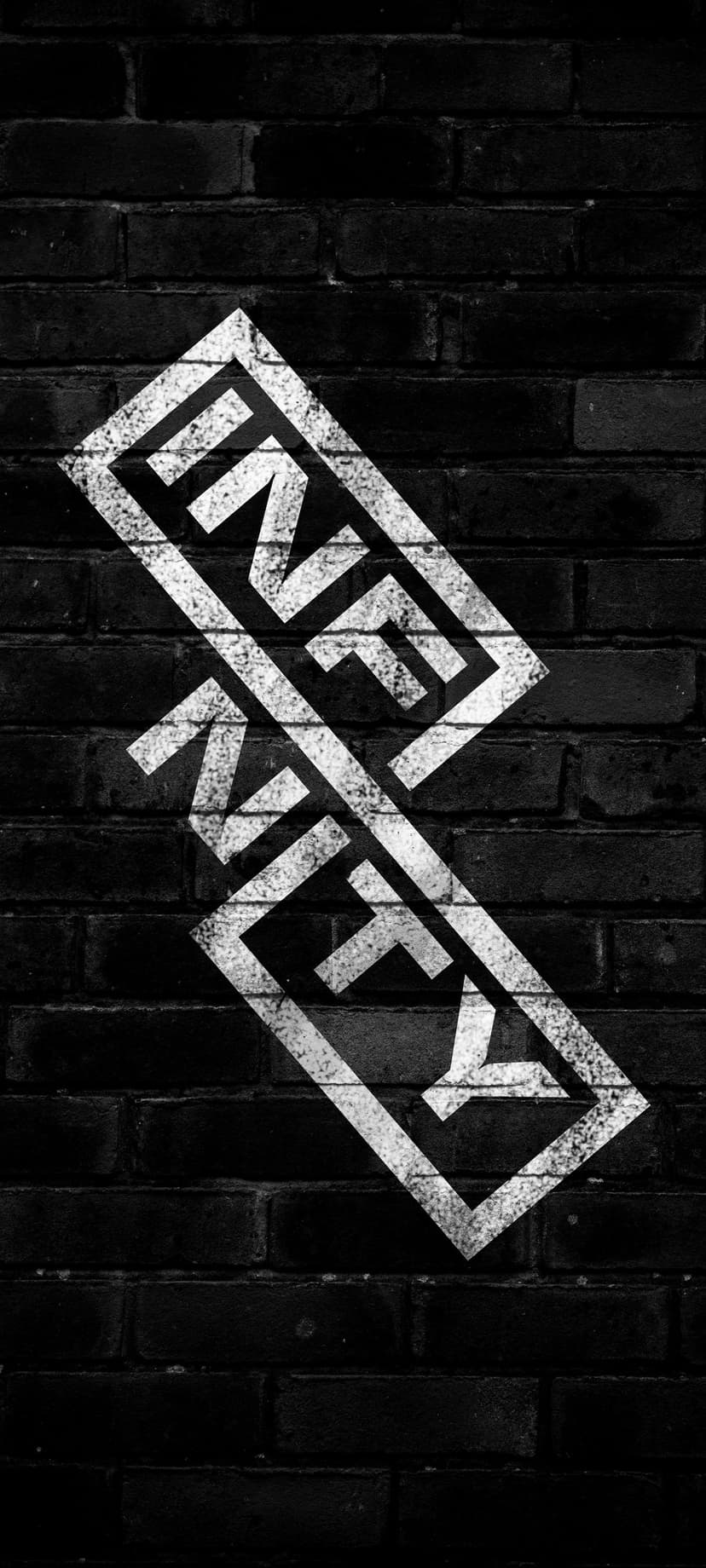 White graffiti letters spell NEKY diagonally across a textured black brick wall with industrial urban styling.