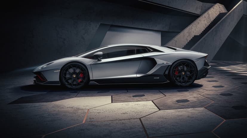 Side view of a silver Lamborghini Aventador on hexagonal tiles in a concrete architectural environment.