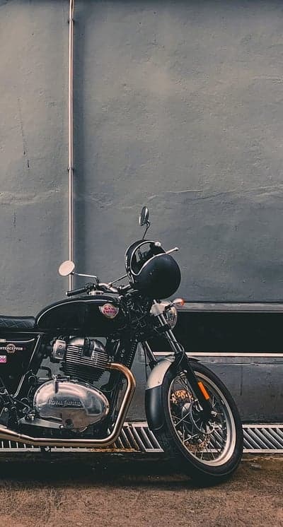 Classic Black Royal Enfield Motorcycle with Helmet