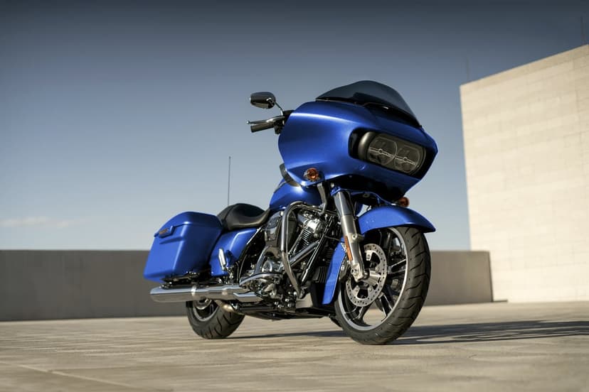 Blue Harley-Davidson Road Glide motorcycle with shark-nose fairing on a concrete rooftop against a clear sky.