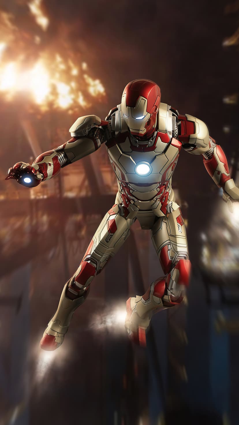 Iron Man in red and gold armor flies through a smoky city street filled with orange fire and rising debris.