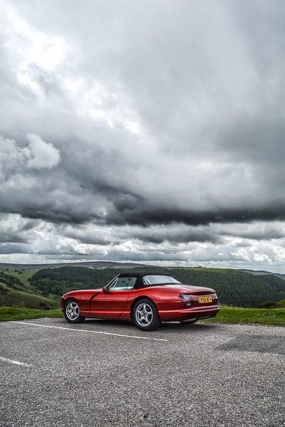Scarlet Sports Car in Moody Highland Valley Phone Wallpaper
