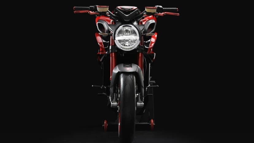 Front view of a red and black sport motorcycle with a round LED headlight against a solid black background.