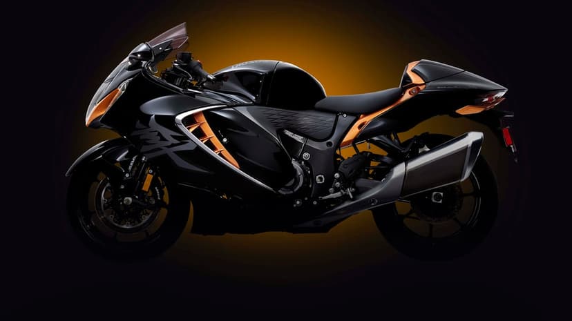 Side profile of a black Suzuki Hayabusa sportbike with copper accents against a dark amber glow background.