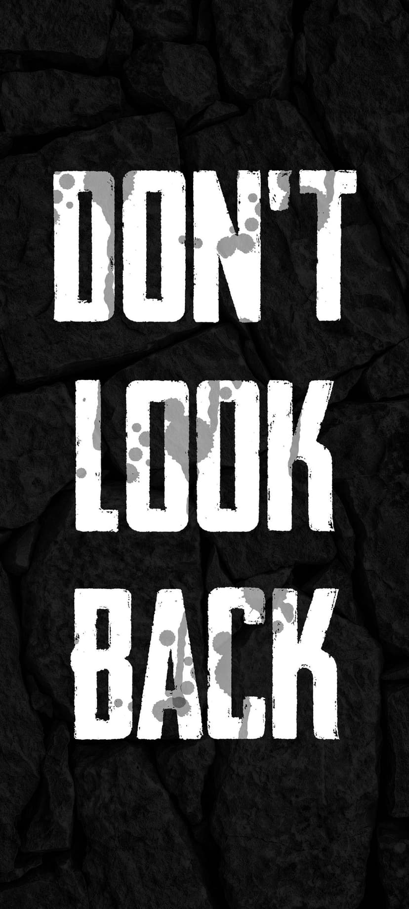 White distressed text saying Don't Look Back centered on a dark grey volcanic rock surface with paint splatters.