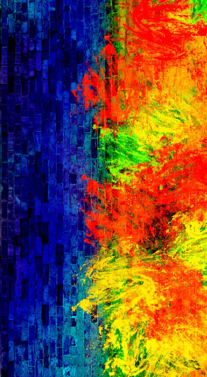 Red and yellow paint splatters erupt against a blue brick wall, creating a vibrant and textured urban pattern.