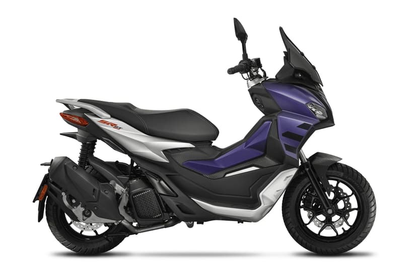 Side view of a purple and silver Aprilia SR GT scooter with rugged tires on a white studio background.