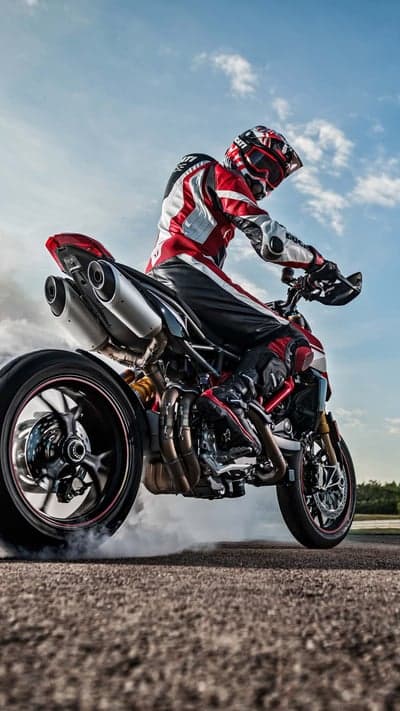 Motorcyclist performing a burnout on a Ducati