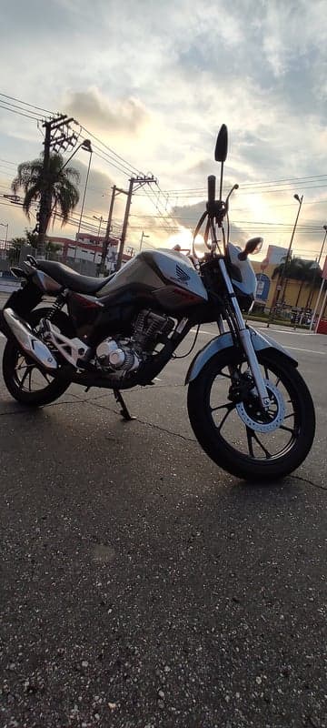 Honda Motorcycle parked at sunset on wet asphalt