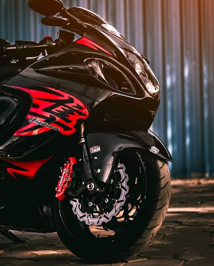 Suzuki Hayabusa motorcycle featuring black fairings, red details, and a high-performance front brake disc system.