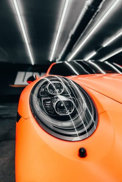 Orange Porsche Headlight Detail Mobile Wallpaper