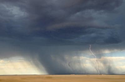 Dramatic lightning strike over a stormy prairie