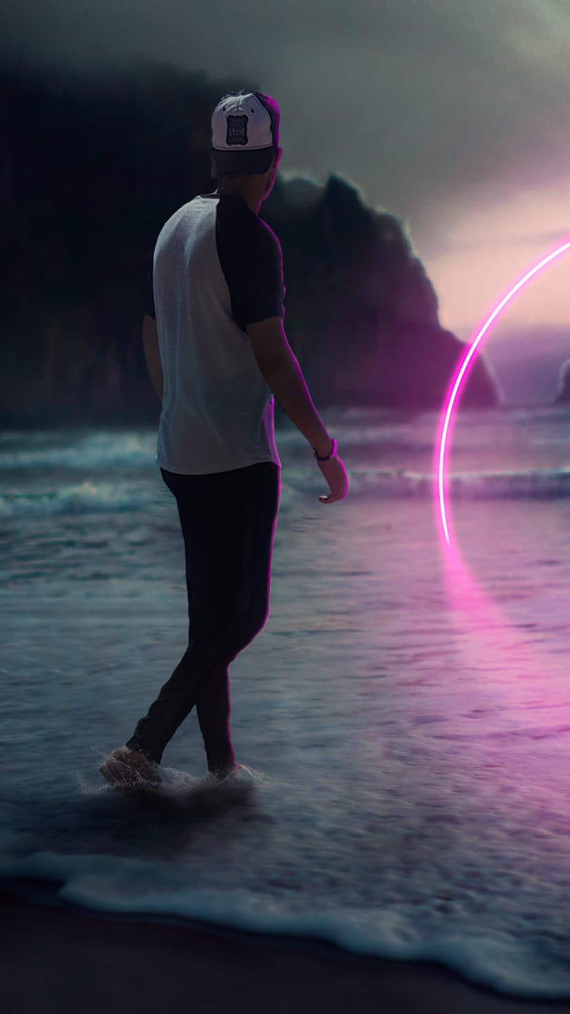 Solitary person walking toward a glowing pink neon ring floating over dark ocean waves under a moody sky.