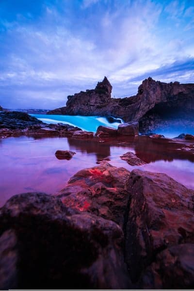 Dramatic Icelandic Waterfall at Dusk with Purple Pool