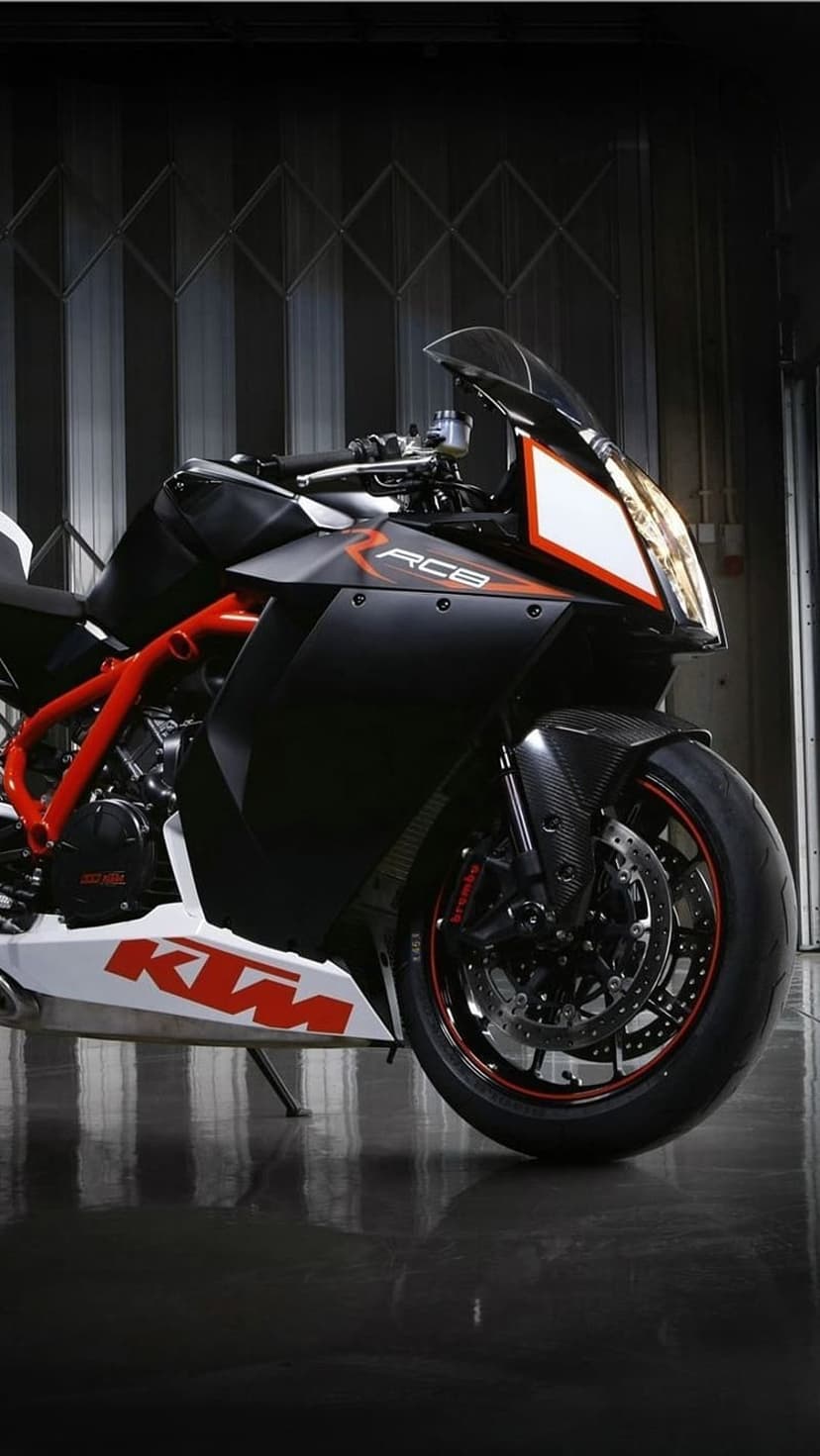 KTM RC8 motorcycle featuring an orange trellis frame, black fairings, and high-performance engine components.