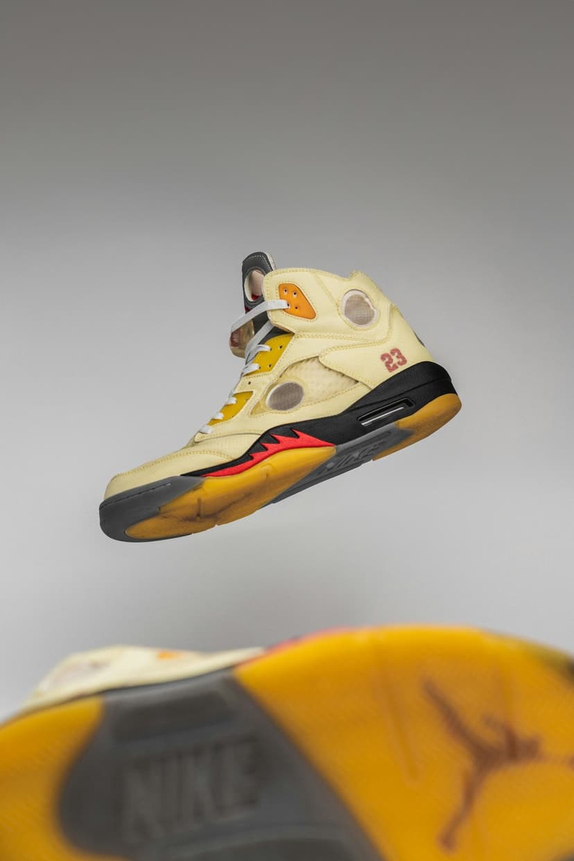 Off-White x Air Jordan 5 Sail sneaker with translucent cream upper, circular cutouts, and a yellowed vintage sole.