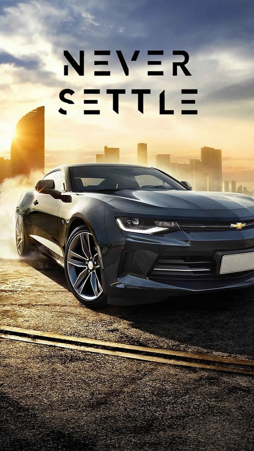 Black Chevrolet Camaro drifting on an asphalt road against a night city skyline with Never Settle text.