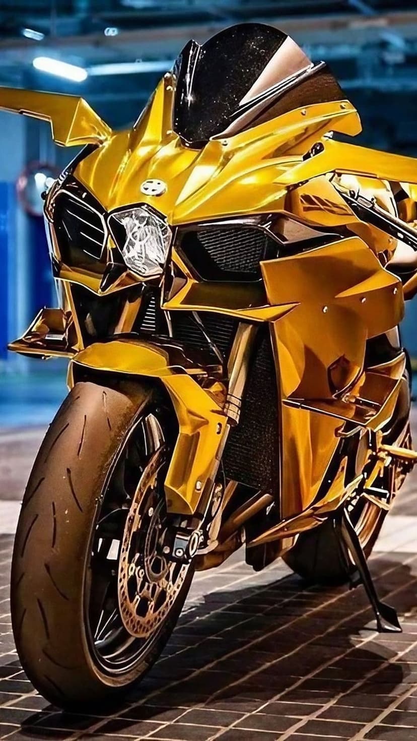 Gold chrome sportbike featuring sharp aerodynamic fairings and a large tire reflecting bright ambient lighting.