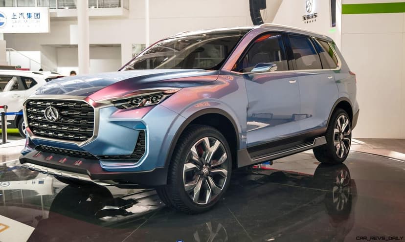 Iridescent blue luxury SUV with chrome accents and large alloy wheels parked on a reflective showroom floor.