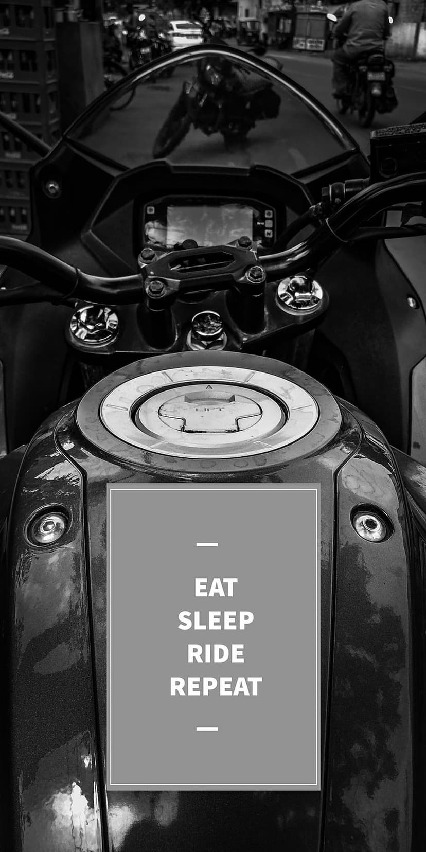 Motorcycle fuel tank with Eat Sleep Ride Repeat text on a high-contrast monochrome metallic vertical surface.