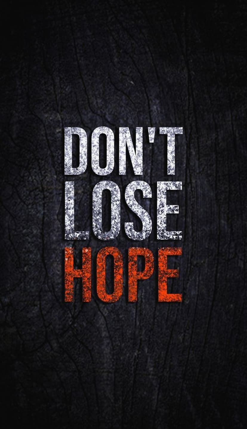 Silver and orange lettering spelling Don't Lose Hope sits on a weathered dark wood surface with visible grain.
