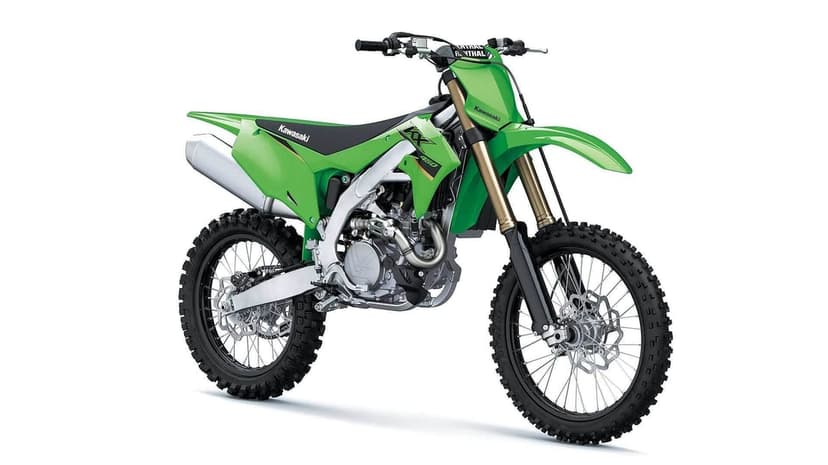 Kawasaki KX450 motocross bike with lime green fairings and knobby tires against a plain white studio background.