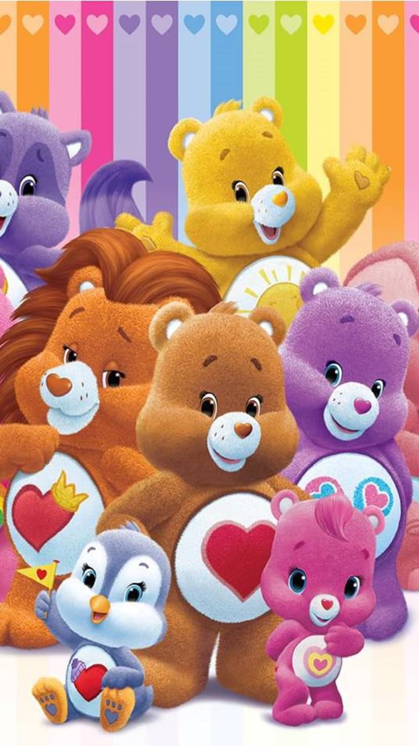 Care Bears and a baby penguin stand together in front of a colorful rainbow-striped background with small pink hearts.