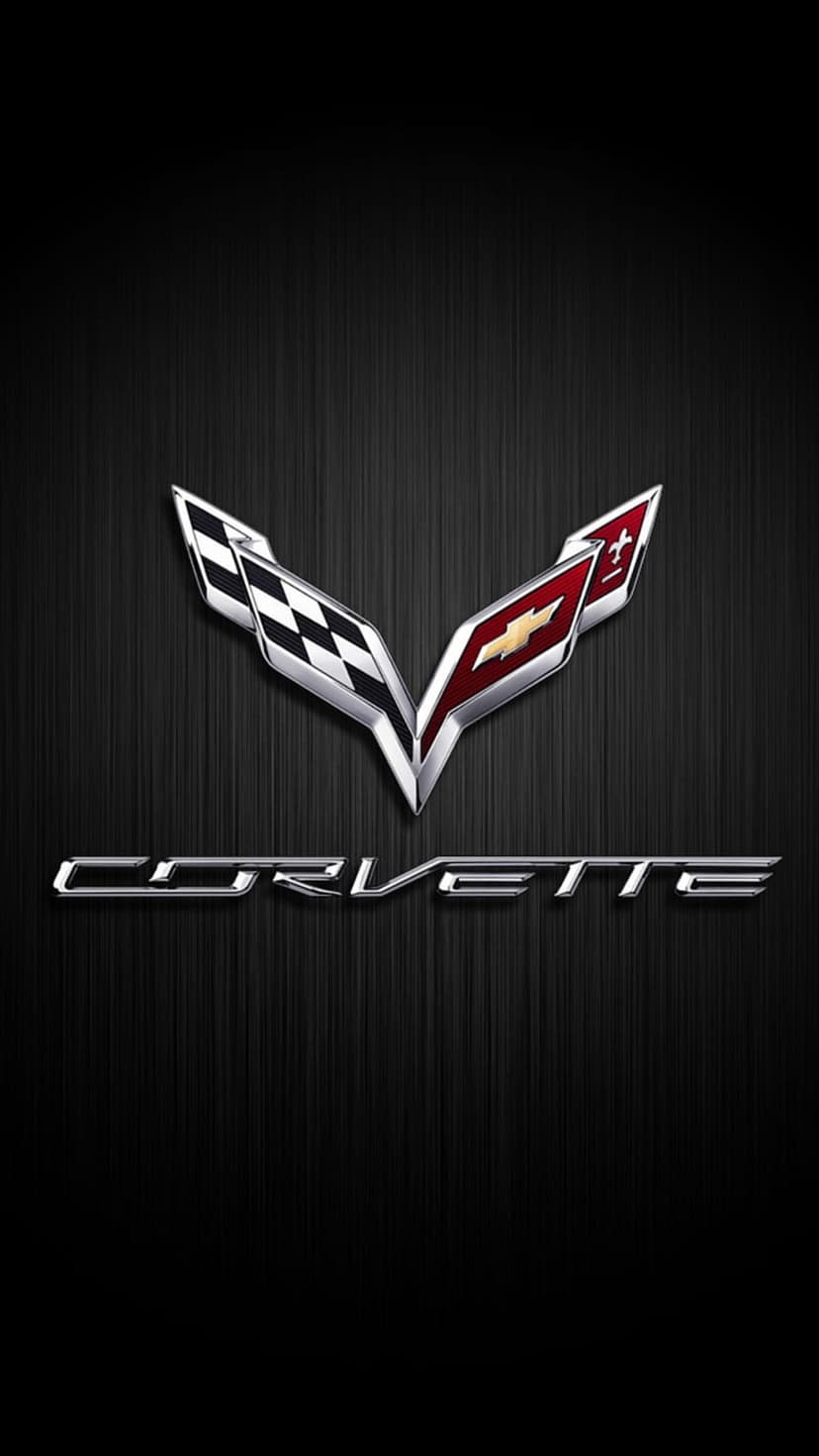 Corvette crossed flags logo and golden bowtie badge centered on a dark brushed metal textured surface.