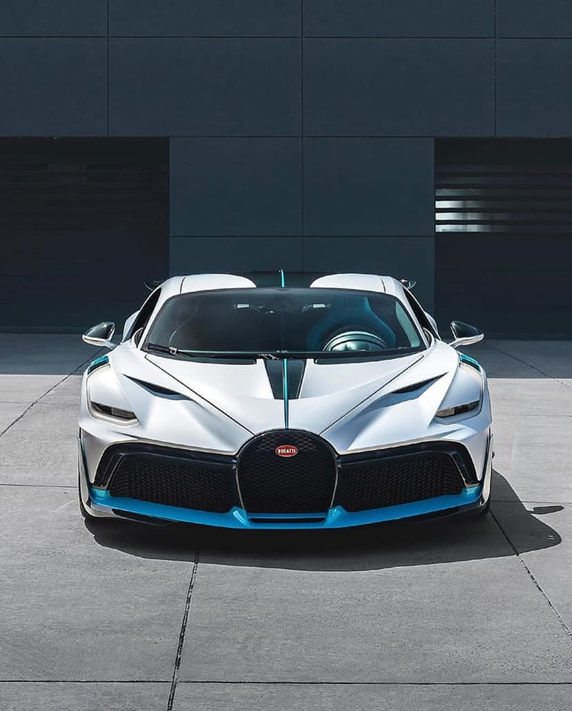 Bugatti Divo hypercar in white and blue featuring an aggressive front grille and sharp LED headlights.