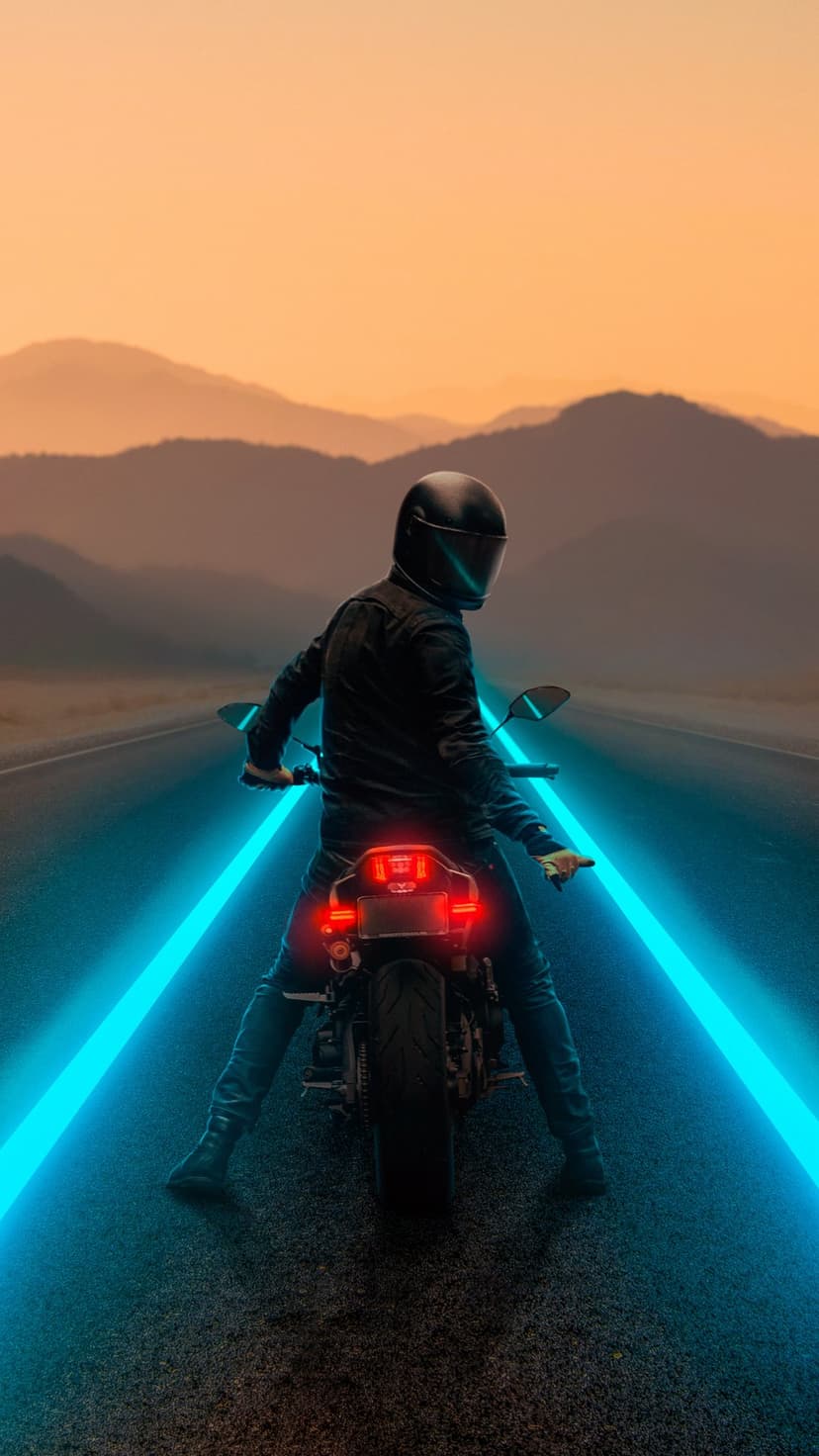 Motorcyclist in a black helmet rides past neon blue light streaks on a road against an orange sunset sky.