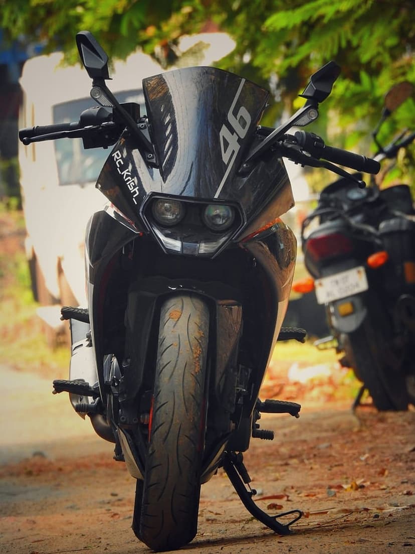 KTM RC motorcycle front view with a yellow 46 decal on the windscreen and sharp headlights in an outdoor setting.
