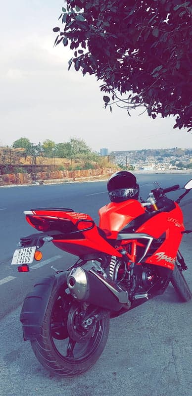 Red Apache RR 310 motorcycle parked by road