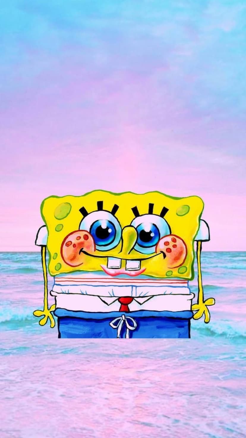 SpongeBob SquarePants stands on a tropical beach under a pink sky with ocean waves lapping at the sandy shore.