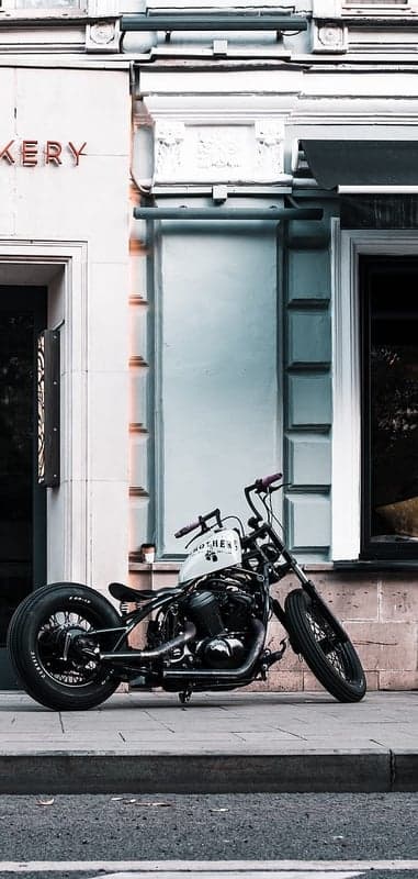 Black Chopper Motorcycle Parked Outside Bakery